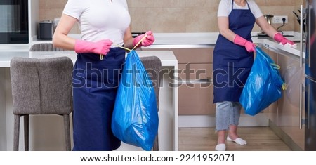 Two women wearing protective rubber gloves holding garbage bags standing in a kitchen. Cleaning service concept. Team work Royalty-Free Stock Photo #2241952071