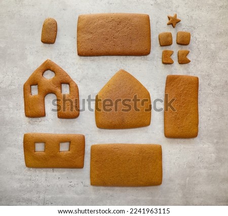 Top view of gingerbread house baked parts. Homemade gingerbread house walls, roof and chimney parts.