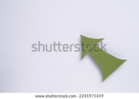 Paper arrow on white background, top view. Space for text