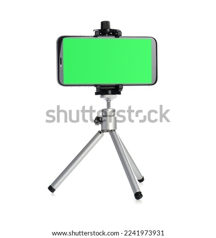 Smartphone with green screen fixed to tripod on white background. Mockup for design