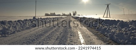 Winter road. Winter landscape of winding road. Snowy winter on the countryside. Highway leading through snowy fields. Drifts on the road.
Snowy road  of panoramic landscape.