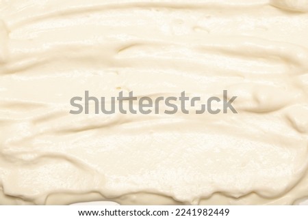 Cake cream texture, sweet whipped cream. Background of yogurt close-up with a pattern. Royalty-Free Stock Photo #2241982449