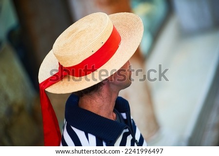 Person with Venetian gondolier hat and red bow, Venice, Italy Royalty-Free Stock Photo #2241996497
