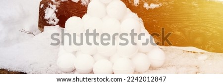 pyramid or a pile of perfect snowballs on frosty winter day in forest or garden outdoor. snowy winter season and fun entertainment in nature. banner. flare