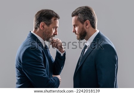 confrontation of two businessmen in suit. photo of businessmen has confrontation look Royalty-Free Stock Photo #2242018139