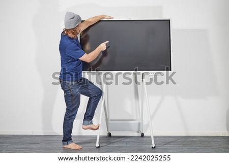Man presenting in front of digital screen