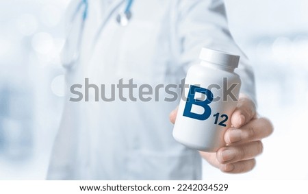 B12 Vitamin, B12 supplements for human health. Doctor recommends taking B12. Doctor gives vitamin B vitamin. Essential vitamins and minerals for humans. Doctor hold bottle with supplement Royalty-Free Stock Photo #2242034529