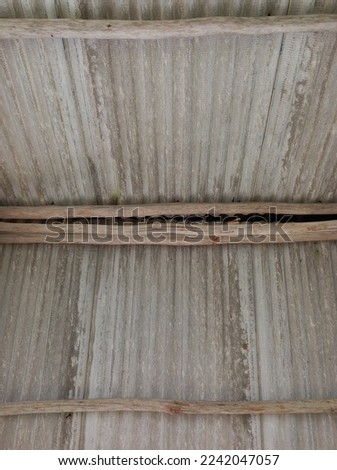 Corrugated roof with wood support, nature photo concept, grey and brown background