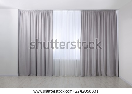 Light grey window curtains and white tulle indoors Royalty-Free Stock Photo #2242068331