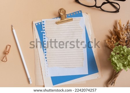 Blank sheet paper notebook on colored background top view. Flat lay.