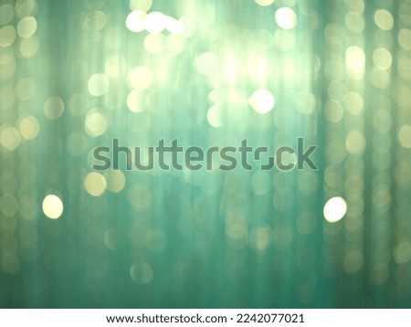 Green curtain background with bokeh.