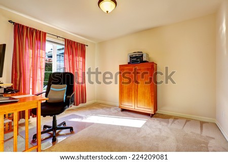 Light ivory office room interior with wooden cabinet. Desk with black whirlpool chair