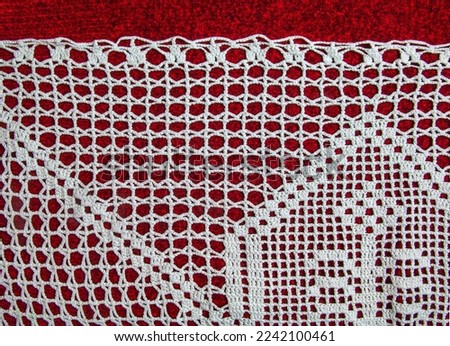 Vintage white lace on red background closeup