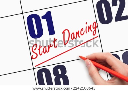 1st day of the month. Hand writing text START DANCING and drawing a line on calendar date. Save the date. Deadline. Business concept Day of the year concept.