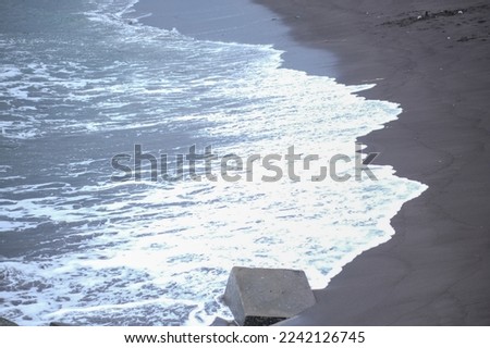 The shores of Glagah beach, Yogyakarta Indonesia, with black sand and strong waves
