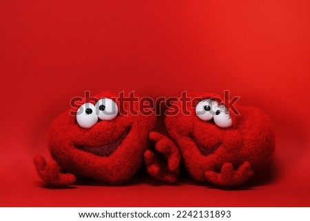 Two toy red hearts on red background with copy space for text, symbol of love, healtcare, valentines day concept