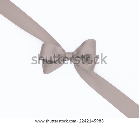 Satin ribbon bow for gift box in gray color, isolated on white background. Background with ribbon bow on white background.