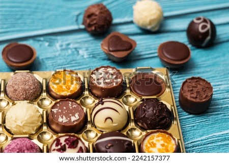Chocolate prailne candies with nuts and dried fruits