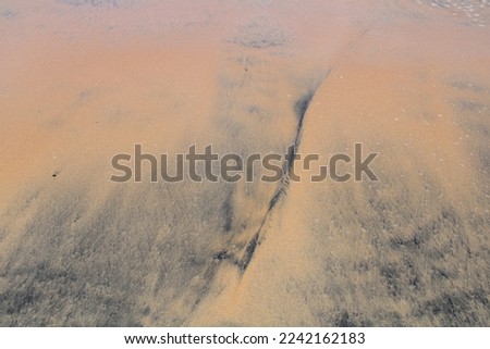 Sand pattern on a wet sandy beach