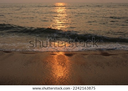 Sun reflection on water and sand during sunset stock photo