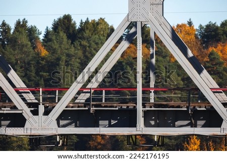 Gray steel truss bridge fragment, railway infrastructure details Royalty-Free Stock Photo #2242176195