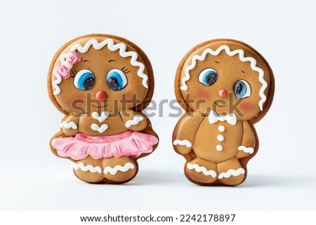 Christmas gingerbread men with white icing isolated on white background. Homemade festive traditional gingerbread cookies. Gingerbread couple. Merry Christmas