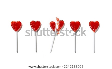 Heart-shaped lollipops among them, one is broken into pieces isolated on white background. Valentine's day. Holiday background Royalty-Free Stock Photo #2242188023