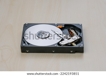 Uncovered  harddisk or hdd storage, inside of harddrive on table 