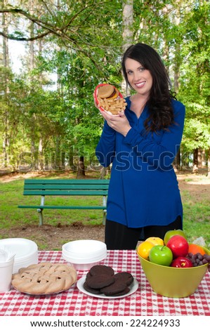 Beautiful woman organizing a checkered picnic table
