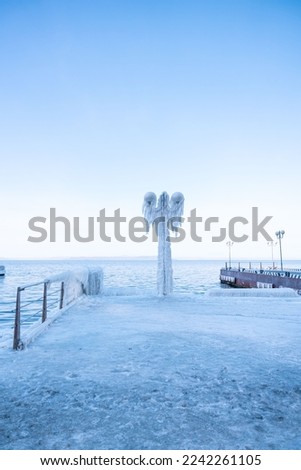 Frozen city after freezing rain. Vladivostok. The street lamp is frozen. Winter city. city in ice. High quality photo
