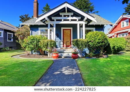 Simple house exterior with tile roof. Front porch with curb appeal Royalty-Free Stock Photo #224227825