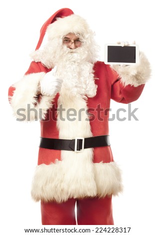 Santa Claus showing digital tablet, giving thumbs up