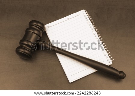 Creating new laws and court concept. Judge gavel on notebook close-up.