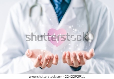 Doctor in white coat holding heartbeat icon for positive healthcare insurance symbol concept, Mental health care, medical check up, heart attack, cardiology, help from specialist concept.