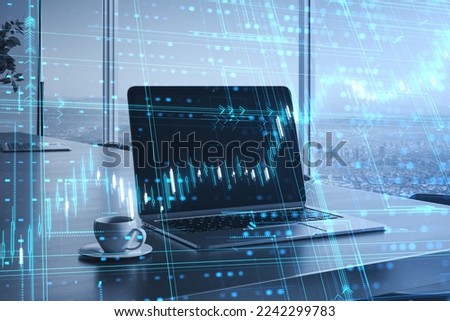 laptop and coffee cup on desktop with glowing candlestick forex grid chart on blurry office window with city view background. Financial growth, trade and stock market concept. Double exposure