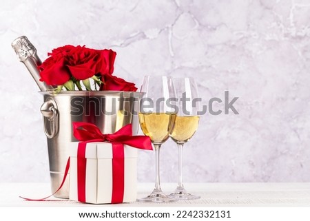 Valentines day card with champagne, rose flowers and gift box. With space for your greetings