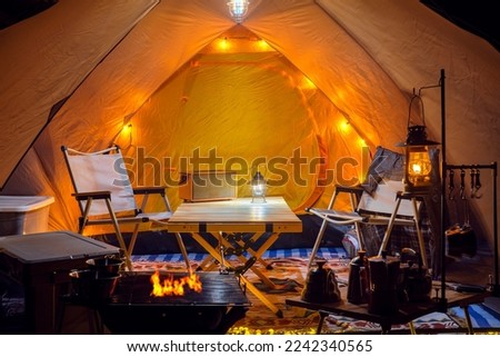 Inside of tent in camping, too many assessories and decoration for cooking, coffee and working between travel in camping trip Royalty-Free Stock Photo #2242340565