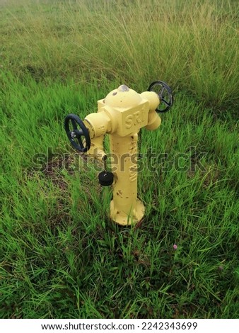 Picture of a fire extinguisher in the middle of a field