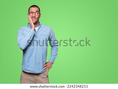 Concerned young man doing a gesture of relief