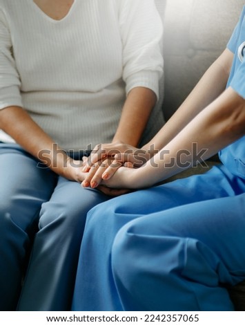 Asian female hands touching old female hand Helping hands take care of the elderly concept. close up. Royalty-Free Stock Photo #2242357065
