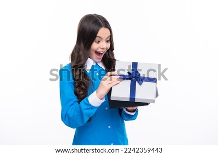 Surprised emotions of young teenager girl. Teenager kid with present box. Teen girl giving birthday gift. Present, greeting and gifting concept.