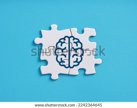 Brain left and right hemispheres connectivity. Human cognition, thinking, problem solving and mental health. Human brain symbol on connected jigsaw puzzle pieces. Royalty-Free Stock Photo #2242364645