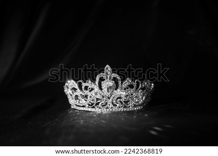 Elegance luxury royal crown on satin, silk background. Black and white Royalty-Free Stock Photo #2242368819