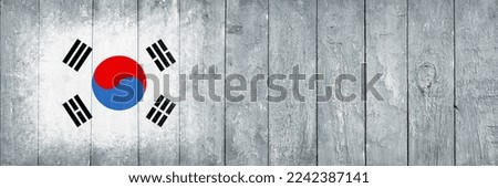 Flag of South Korea. Flag is painted on a gray wooden plank surface. Wooden background. Plywood surface. Copy space. Textured creative background