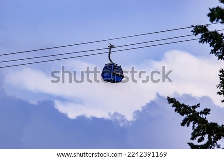 Abha, Saudi Arabia - October 1st 2021- A beautiful picture of the cable car hanging on its way with the blue sky