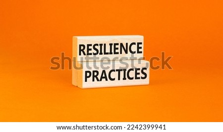 Resilience practices symbol. Concept word Resilience practices typed wooden blocks. Beautiful orange table orange background. Business and resilience practices concept. Copy space.