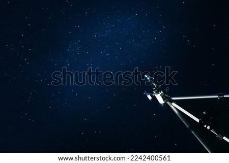 Modern telescope and beautiful sky with stars in night outdoors, low angle view. Learning astronomy