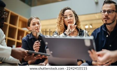 Female Manager Leading a Meeting About Sustainability and Ethnicity with her Multiethnic Teammates. Young Group of Employees Presenting Their Project Ideas To Startup CEO. Medium Shot Royalty-Free Stock Photo #2242410115