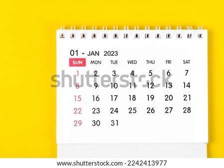 January 2023 desk calendar on yellow color background.