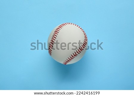 Baseball ball on light blue background, top view. Sports game